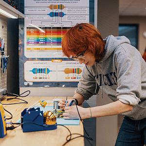 Maker Lab supervisor Adwyn Burdett’27 experiments with a motherboard.